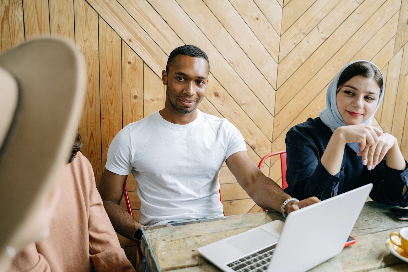 employees talking at laptop