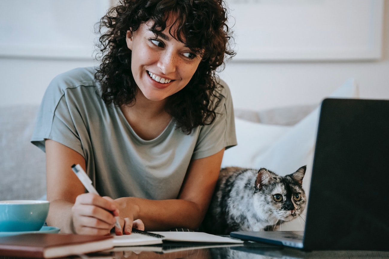 employee and cat sitting in front of computer